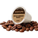 Ekocups compostable decaf medium roast coffee pod surrounded by coffee beans on a white background