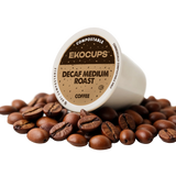 Ekocups compostable decaf medium roast coffee pod surrounded by coffee beans on a white background