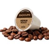 Ekocups compostable coffee pod surrounded by coffee beans on a white background