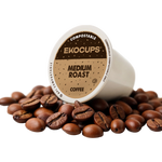 Ekocups compostable coffee pod surrounded by coffee beans on a white background